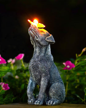 Goodeco dog statue with solar butterfly in the garden adds gentle evening illumination.