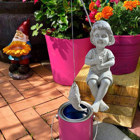 Goodeco Fisherboy display beside waterfall creates tranquil focal point.