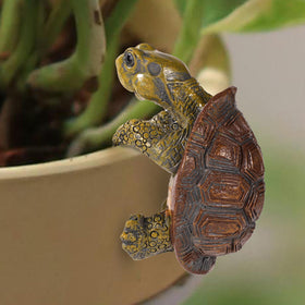 Gosknor tortoise figure plant pot hanger enhances indoor and outdoor garden appeal.