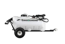 Grass Guardian 25-gallon trailer sprayer unit in action for efficient lawn coverage.