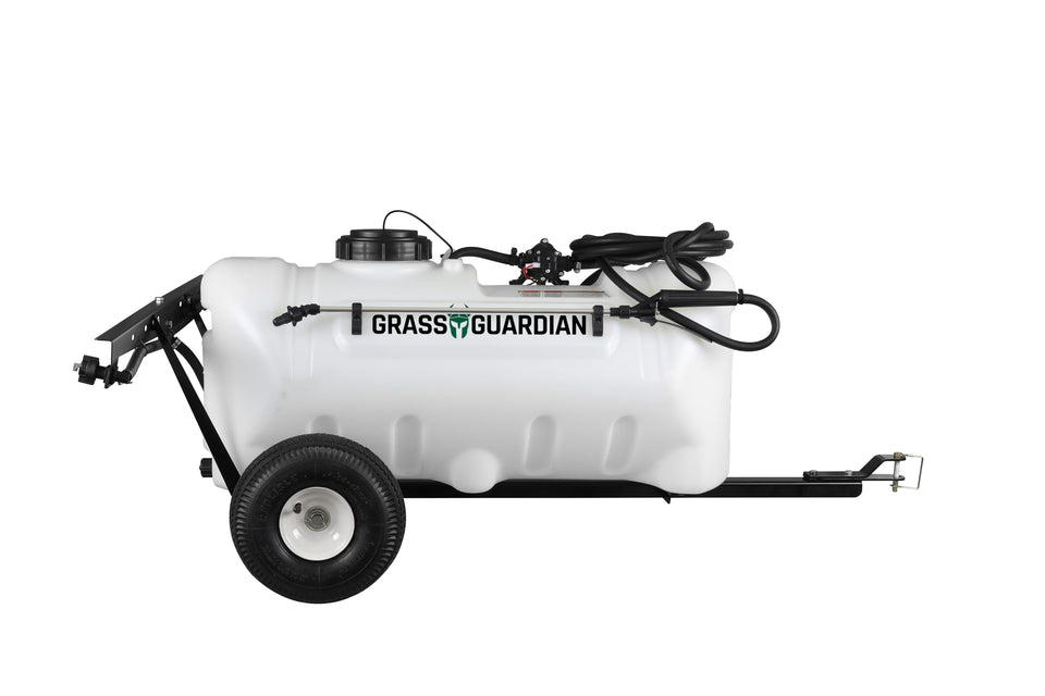 Grass Guardian 25-gallon trailer sprayer unit in action for efficient lawn coverage.