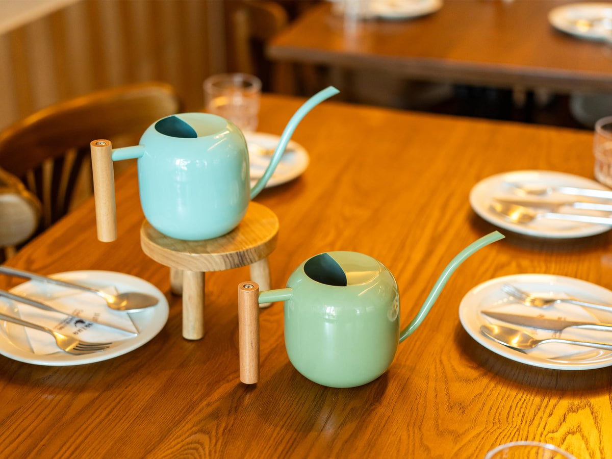 Wooden handle provides a comfortable grip during watering sessions.
