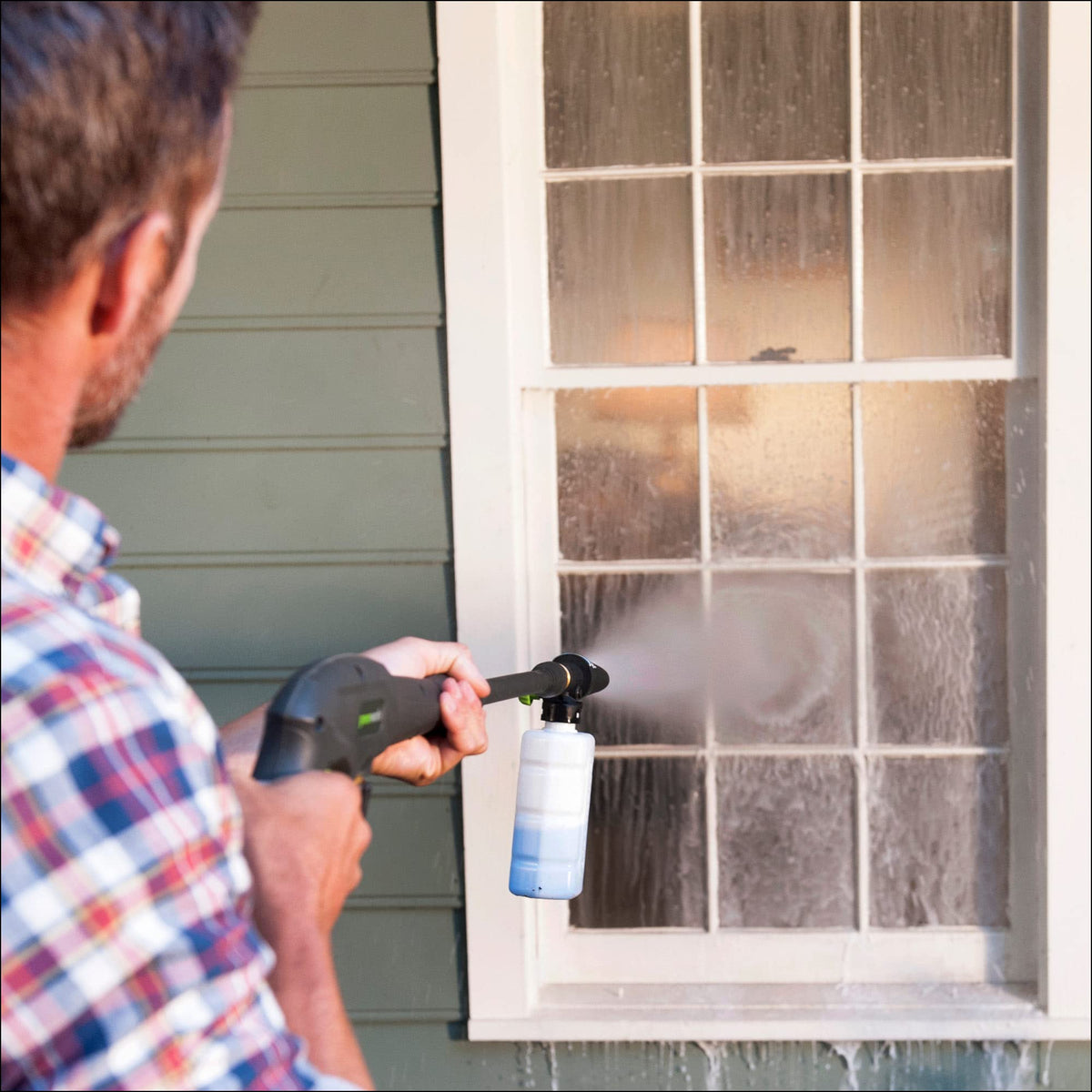 Outdoor cleaning setup with Greenworks soap applicator ready for foamy application.