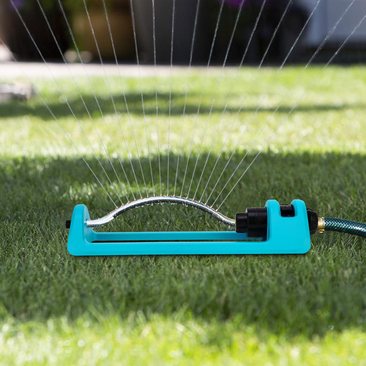 GUDWING sprinkler blue body visible in outdoor setting