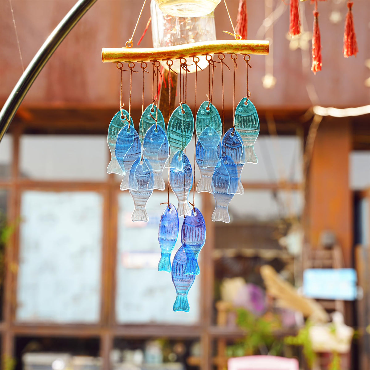 Hyaline & Dora sea wind chime showcases blue glass fish for coastal party ambiance.