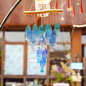 Hyaline & Dora sea wind chime showcases blue glass fish for coastal party ambiance.