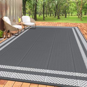 HappyTrends outdoor rug on sunlit patio, spacious surface for outdoor gatherings.