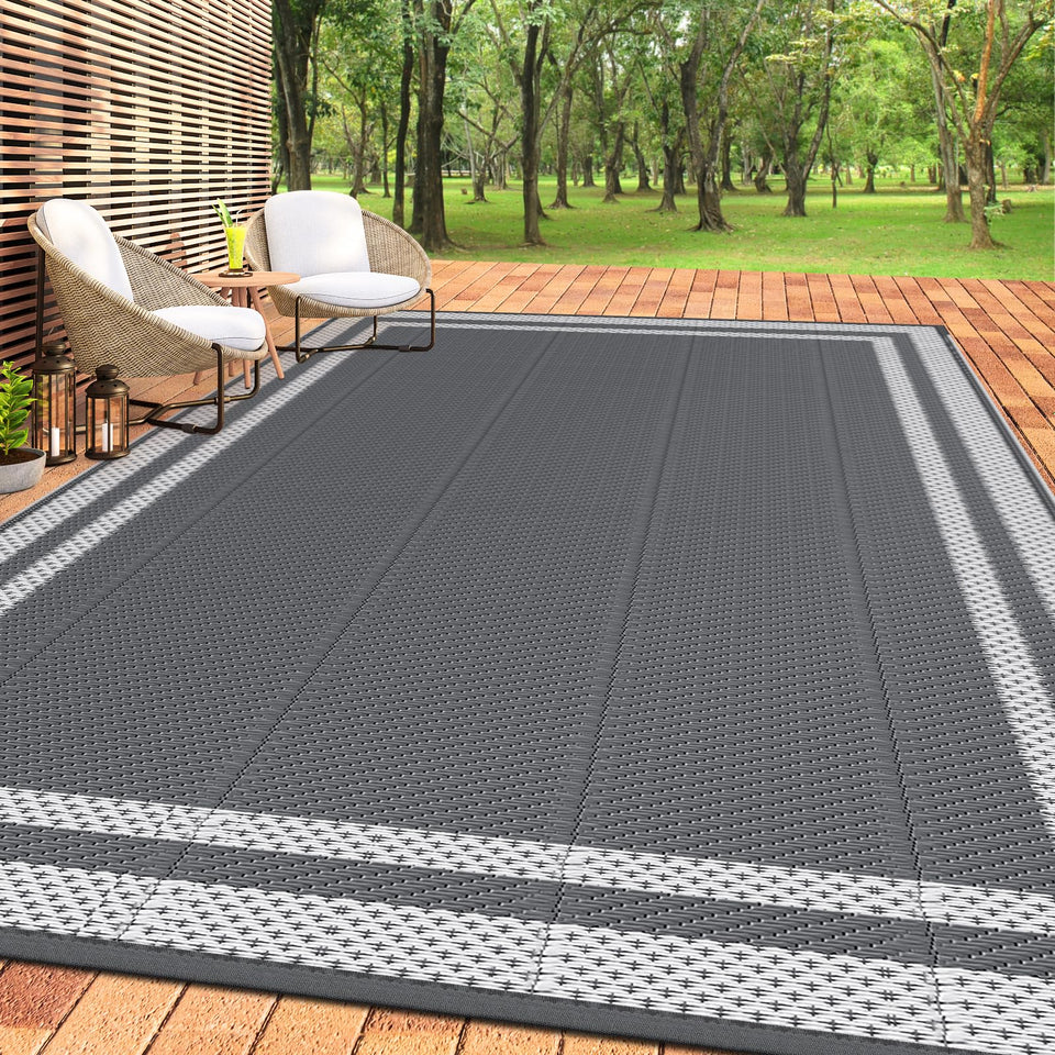 HappyTrends outdoor rug on sunlit patio, spacious surface for outdoor gatherings.