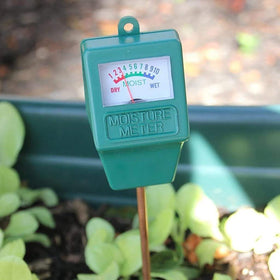 Hathdia compact moisture meter ready for outdoor use in a patio garden.