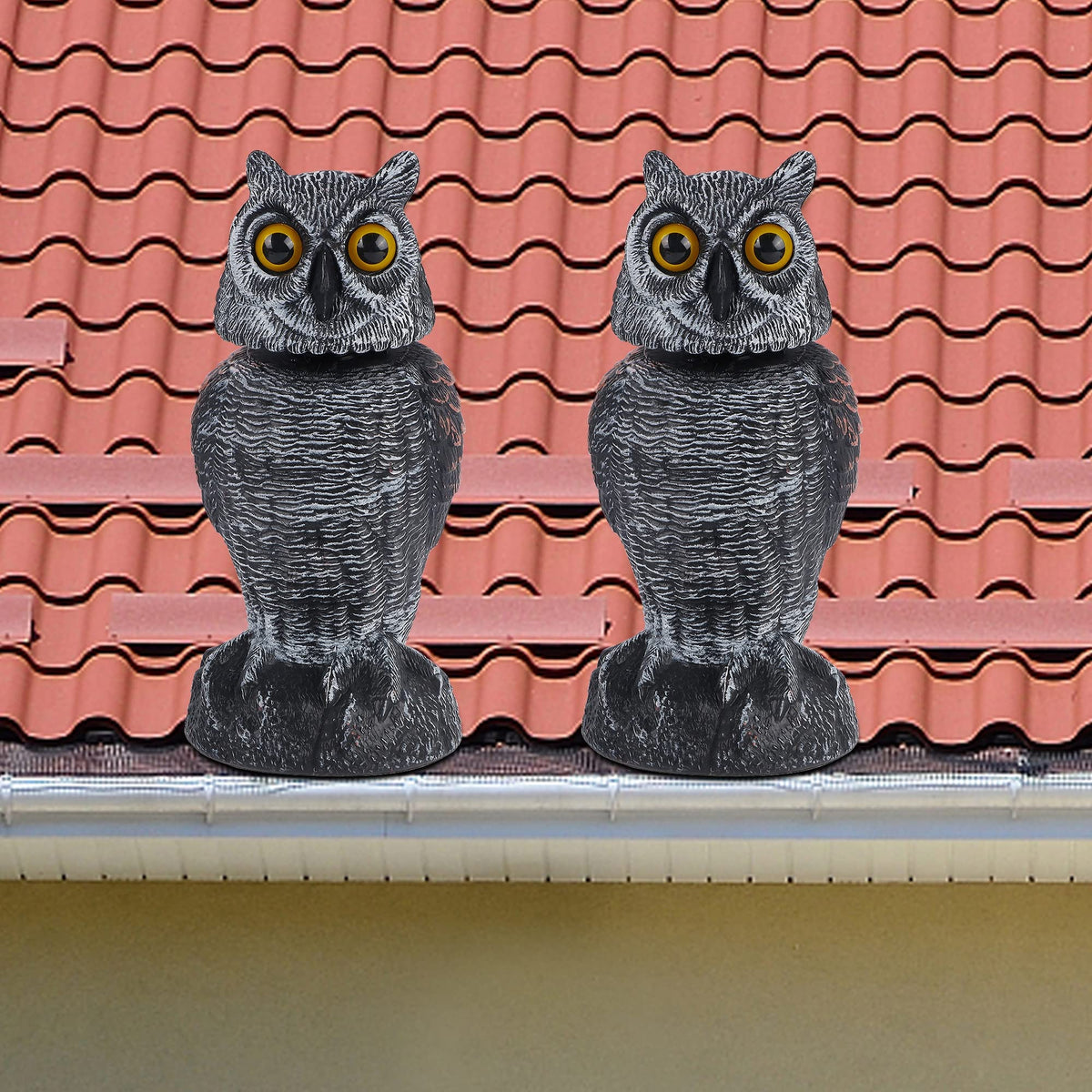 Hausse garden owl pest deterrent placed in a yard or orchard.