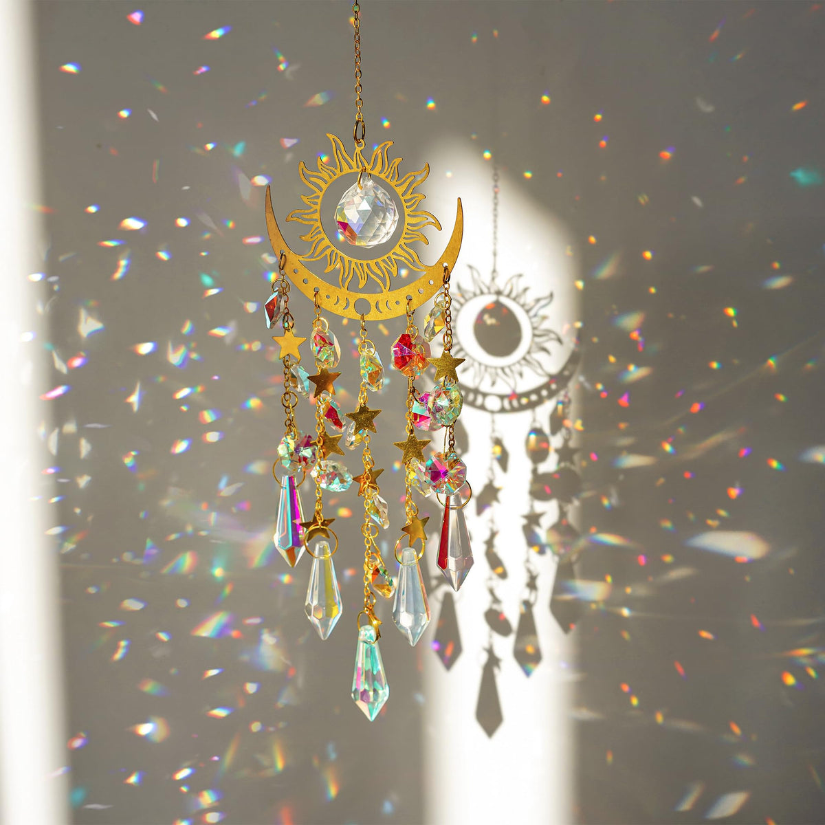 H&D HYALINE & DORA crystal sun moon suncatcher on a sunlit window creating rainbow light