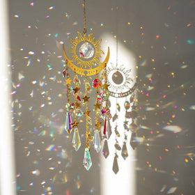 H&D HYALINE & DORA crystal sun moon suncatcher on a sunlit window creating rainbow light