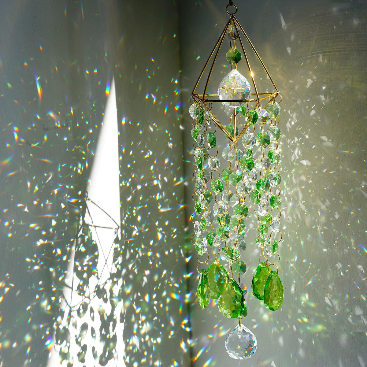 HDCRYSTALGIFTS crystal suncatcher with green rainbow prisms brightening windows