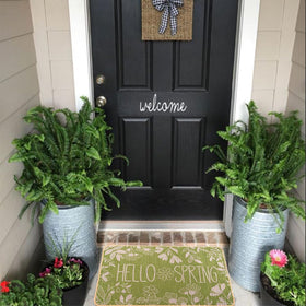 Heirloom Haven Hello Spring mat showcasing waterproof surface for outdoor durability