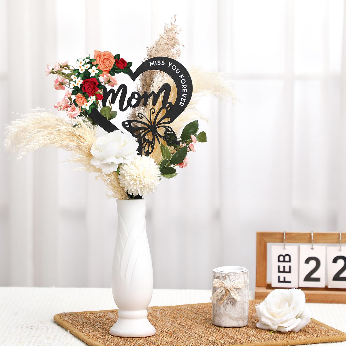 Hoemwarm floral embellishments with roses lilies daisies—adds solemn beauty to memorial marker.