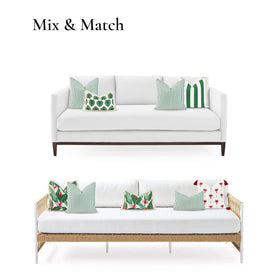 Outdoor patio scene with green striped Hofdeco pillow on a sofa