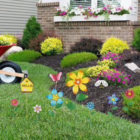Hogardeck yard art enhances planters, beds, and pathways.