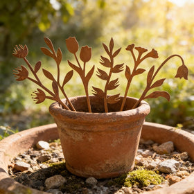 Hogardeck outdoor decor stake with fern design enhances flower beds.