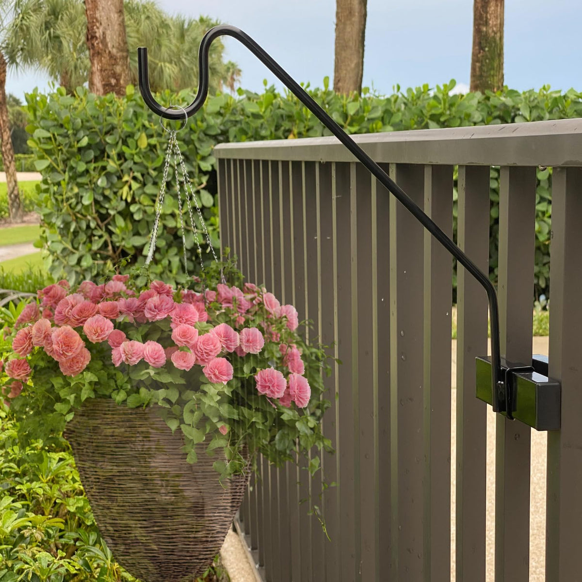 Hold It Mate premium hook on a vertical spindle railing supports a flower basket.