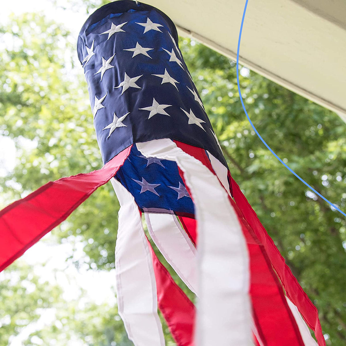 Homarden windsocks frame outdoor parties with bold red, white, and blue motion.