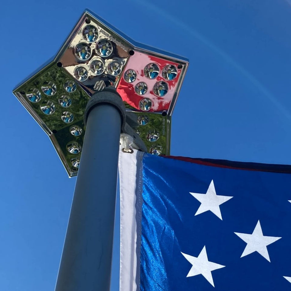 HOME DEPUTY Solar Star flag light on top of a pole, brightens flags at dusk.
