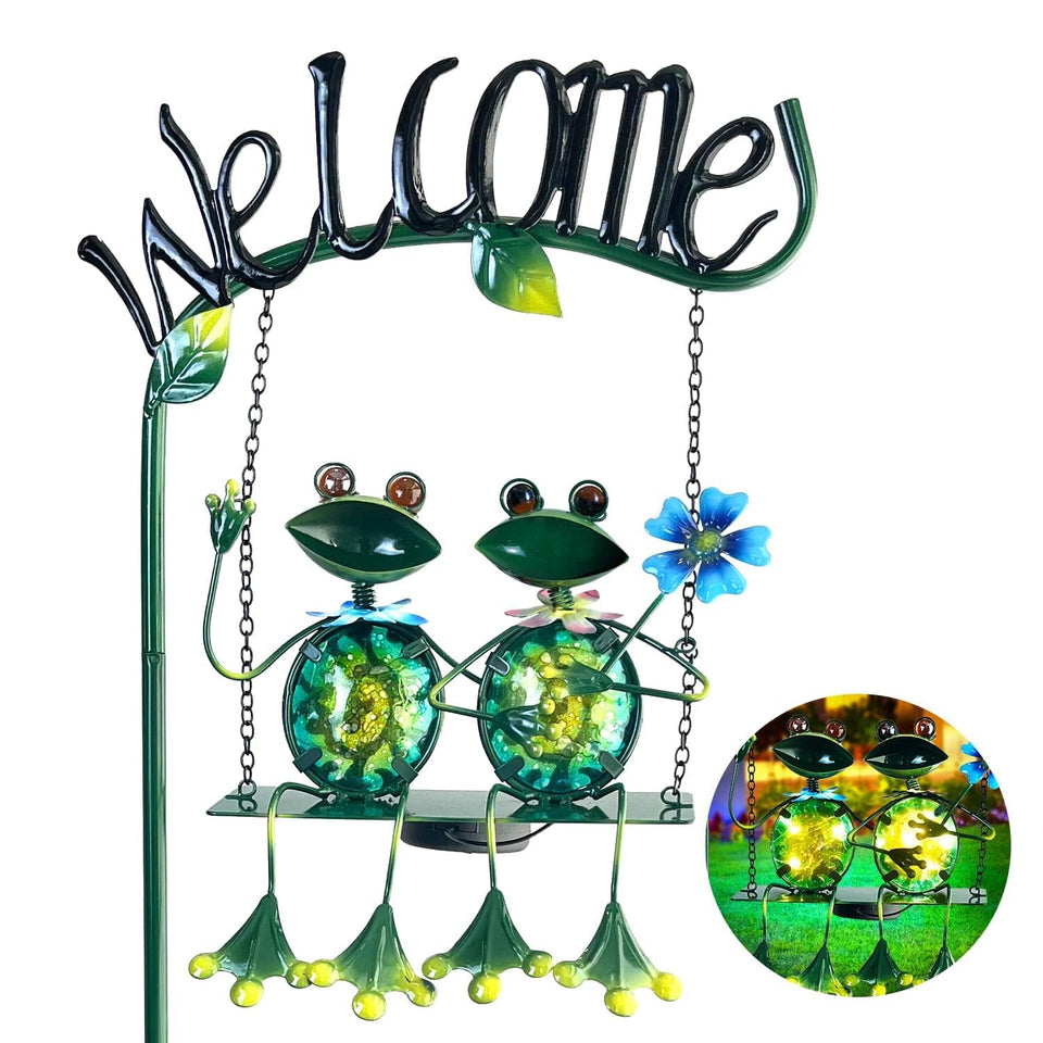 HONGLAND solar lights illuminate the frog-swing welcome stake in the garden.