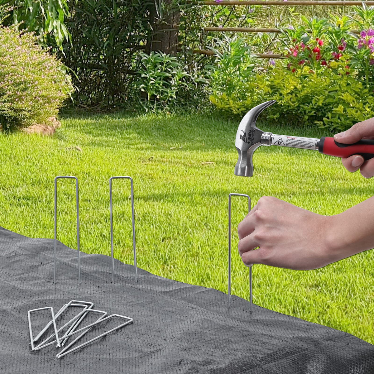 HongWay stakes securing landscape fabric and tarpaulins in a yard