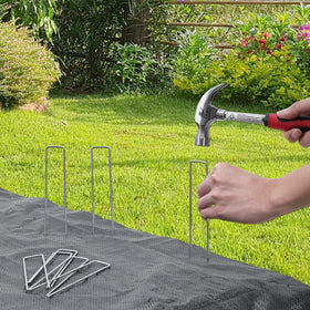 HongWay stakes securing landscape fabric and tarpaulins in a yard