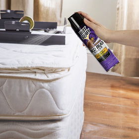Hot Shot Bed Bug Killer aerosol on luggage for fast treatment.