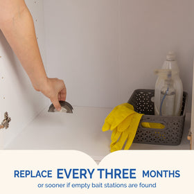 Cabinet-edge placement by wall with Hot Shot Ultra Liquid Roach Bait.