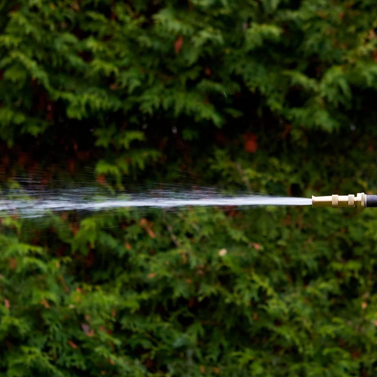 Hourleey hose nozzle in use for watering garden and cleaning car.