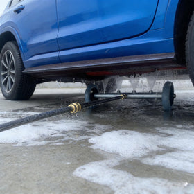 Hourleey undercarriage cleaner in action removing dirt beneath vehicles efficiently