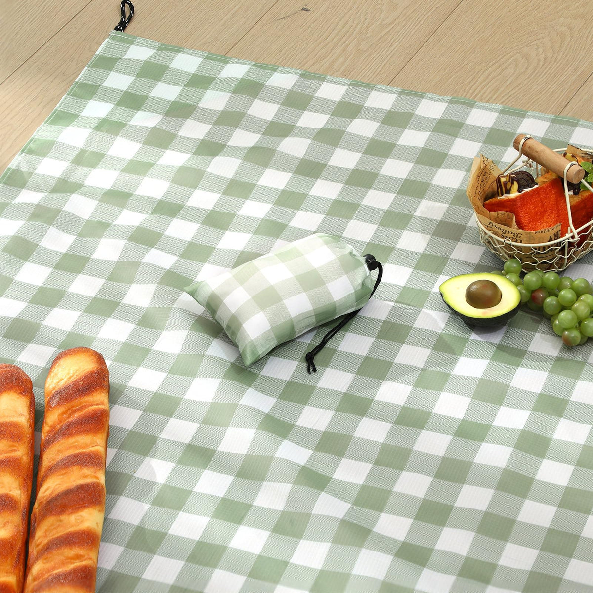 HunnmingRe green gingham picnic blanket laid flat for 55x60 inch setup, ideal for outdoor dining.