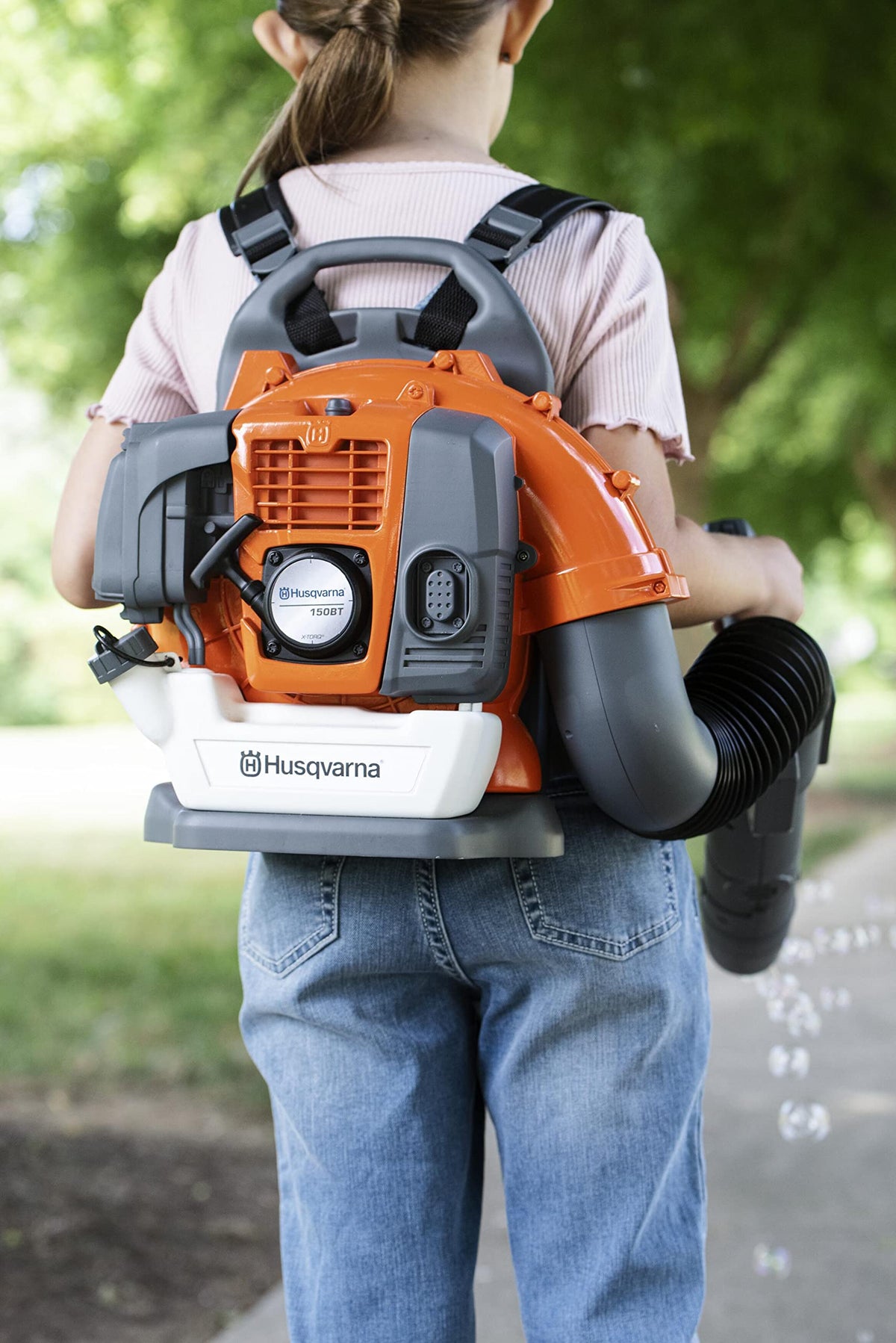 Husqvarna toy leaf blower shows airflow via streamers for sensory feedback.