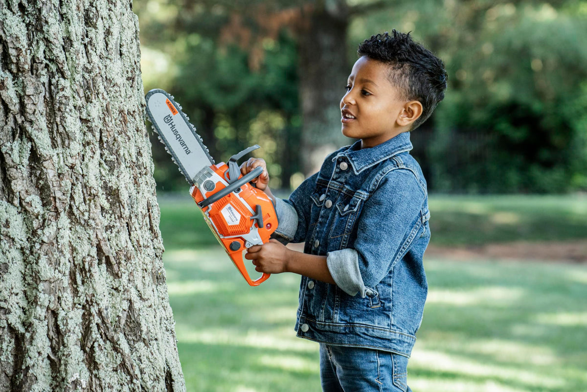 Husqvarna 550XP toy chainsaw suitable for ages 3 and up for safe fun.