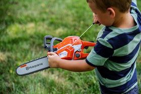 Husqvarna 550XP toy chainsaw showing rotating chain for tactile pretend play.