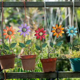 HUTHDAK 16-14 inch tall stakes frame plant beds with colorful focal points.
