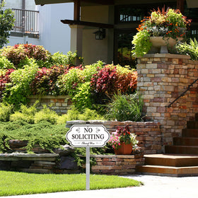 yard display of i-CowFun no soliciting sign in outdoor environment