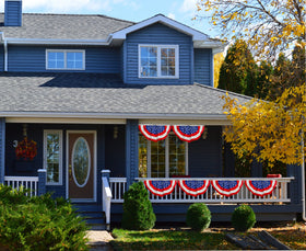 Iconikal American flag bunting ideal for porch celebrations.