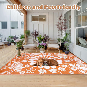 Ileading rug with reversible floral design offers playful style for patios and decks.