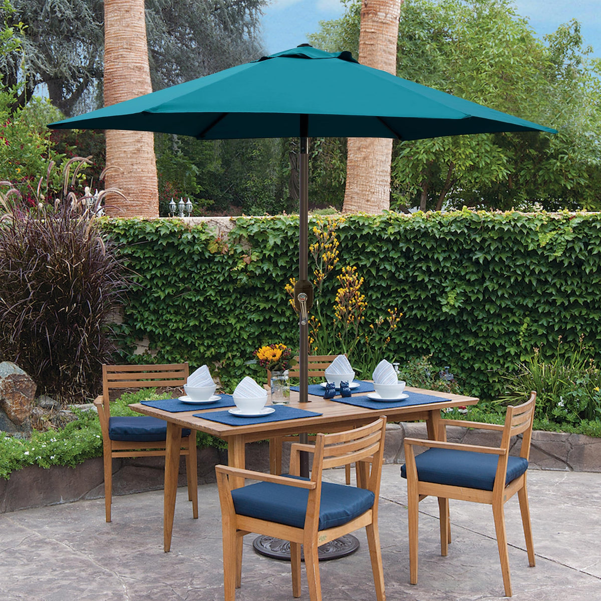 Blissun cerulean outdoor umbrella over dining setup with 2-4 chairs
