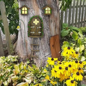 IMOFEE glow-in-dark fairy windows illuminate a garden wall scene.