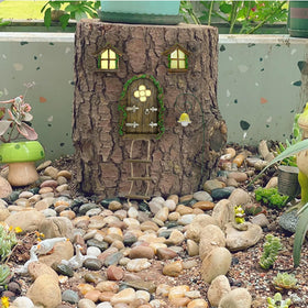 IMOFEE gnome-house mounted on a tree adds a whimsical outdoor focal point.
