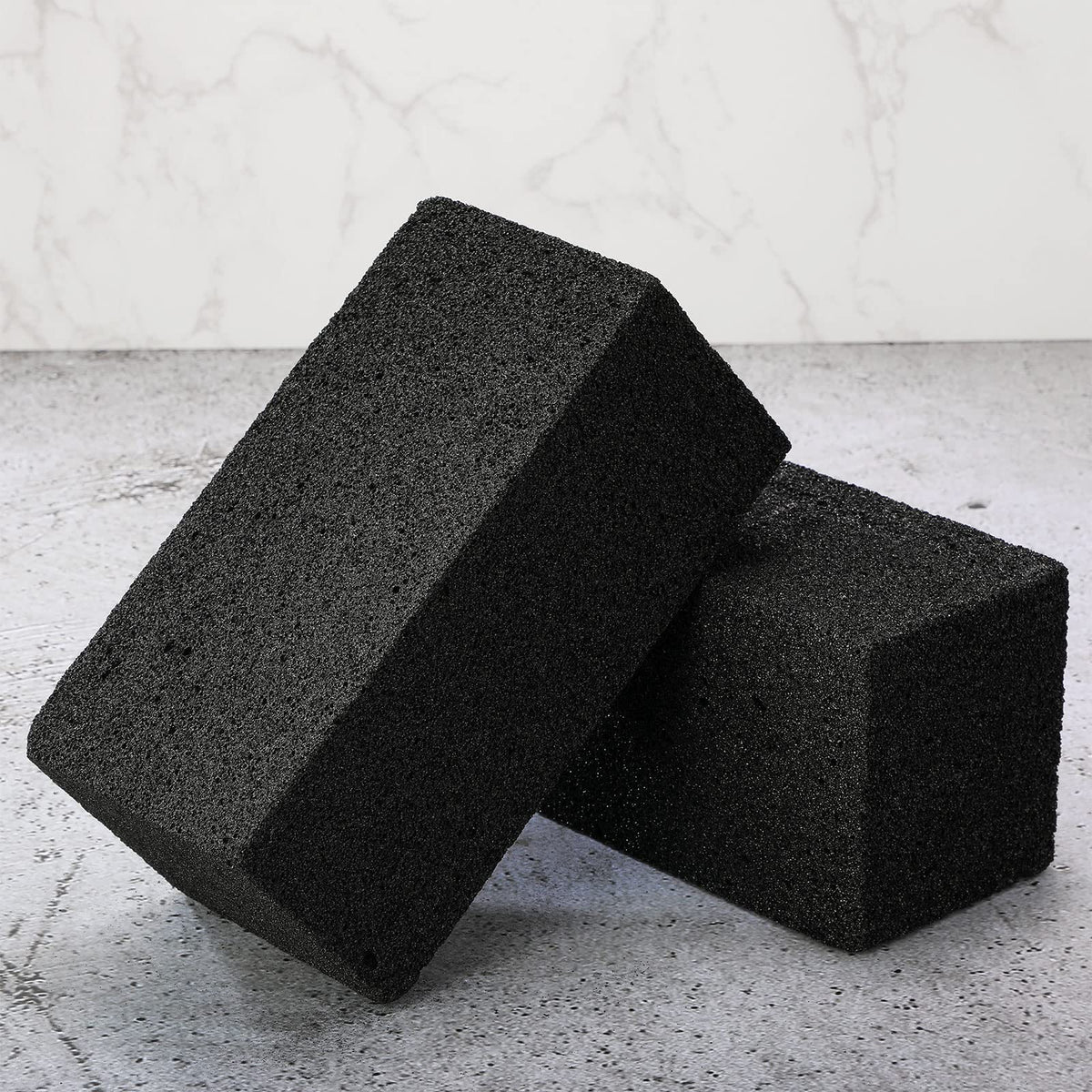 Irenare grill-brick-in-use on a hot grill to scrub residue.