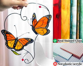 IriCrist monarch butterfly on a branch suncatcher shown on a wall