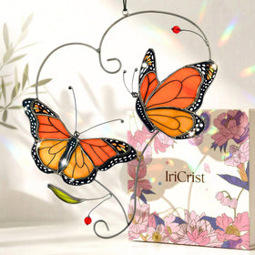 IriCrist Monarch butterfly suncatcher hanging in a window to catch sunlight and color the room