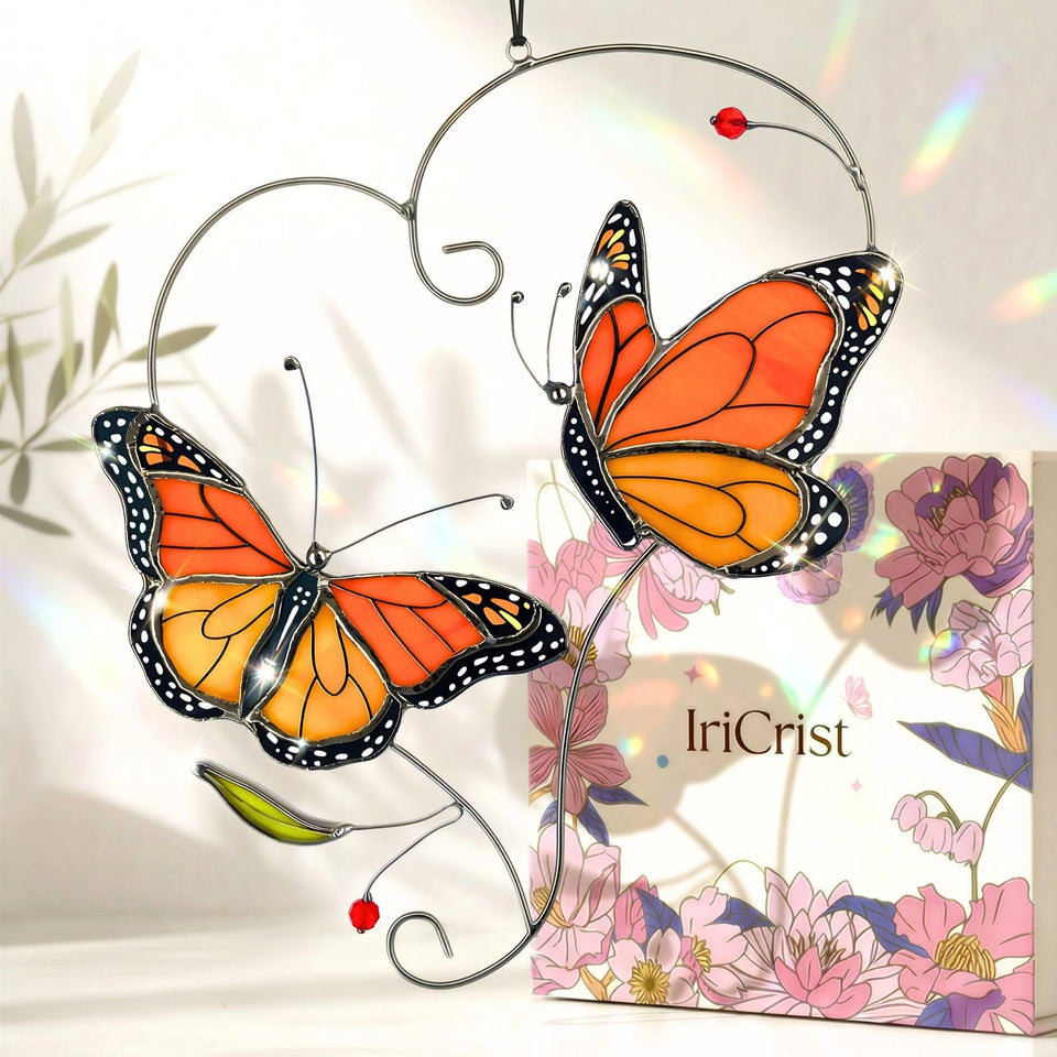 IriCrist Monarch butterfly suncatcher hanging in a window to catch sunlight and color the room
