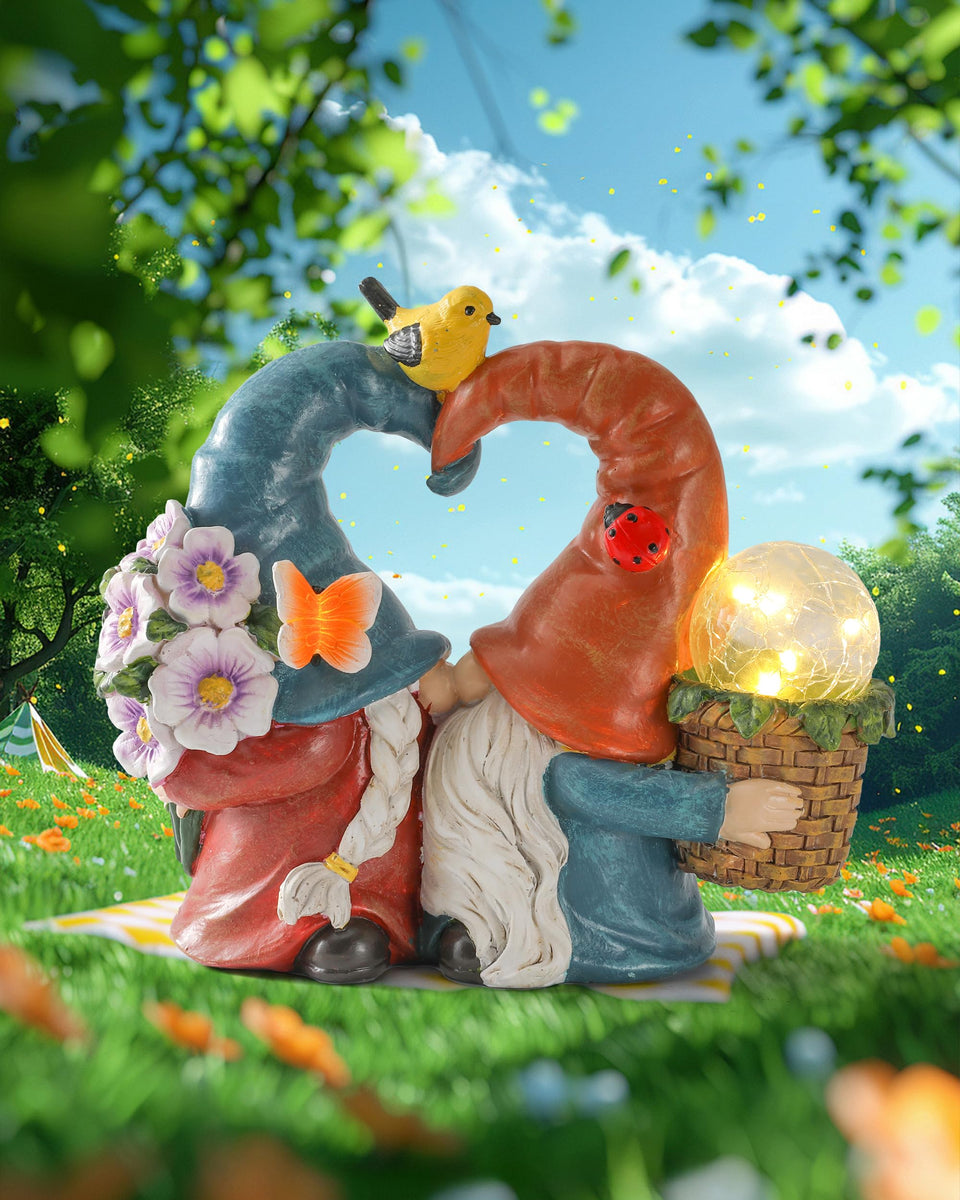 iStatue solar-powered gnomes kissing in garden, adding whimsical romance to outdoor spaces.