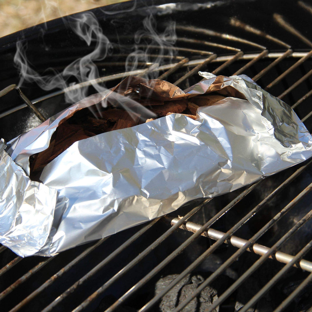 Ribs on the grill boosted by whiskey barrel smoke.