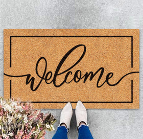 JarThenaAMCS Welcome Mat with natural coir border greets guests and traps dirt.